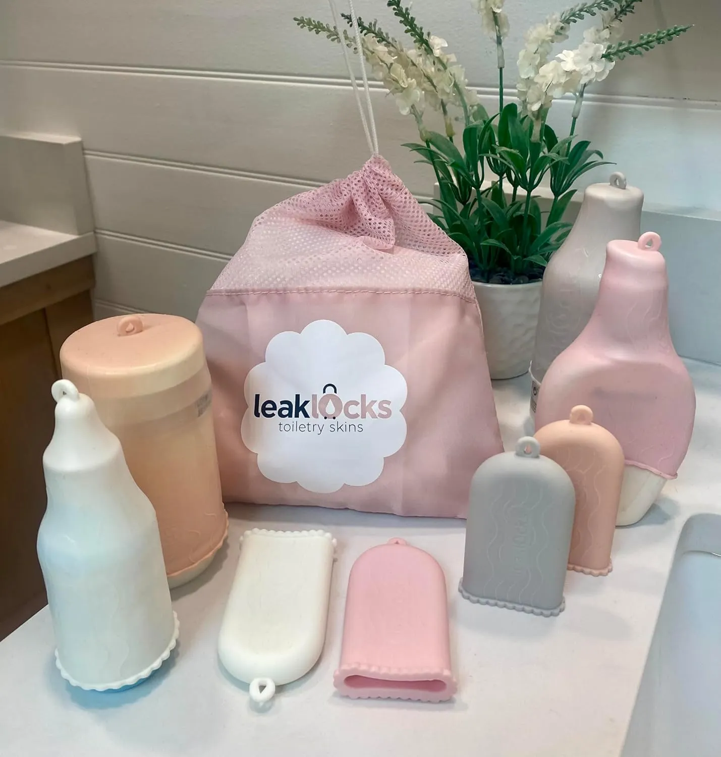 LeakLocks Toiletry Skins 4-Pack w/Travel Bag. Elastic Sleeve for Leak-Proofing Travel Container in Luggage. Fits Standard/Travel Sized Toiletries. Reusable Accessory for Travel Bag Suitcase/Carry-on